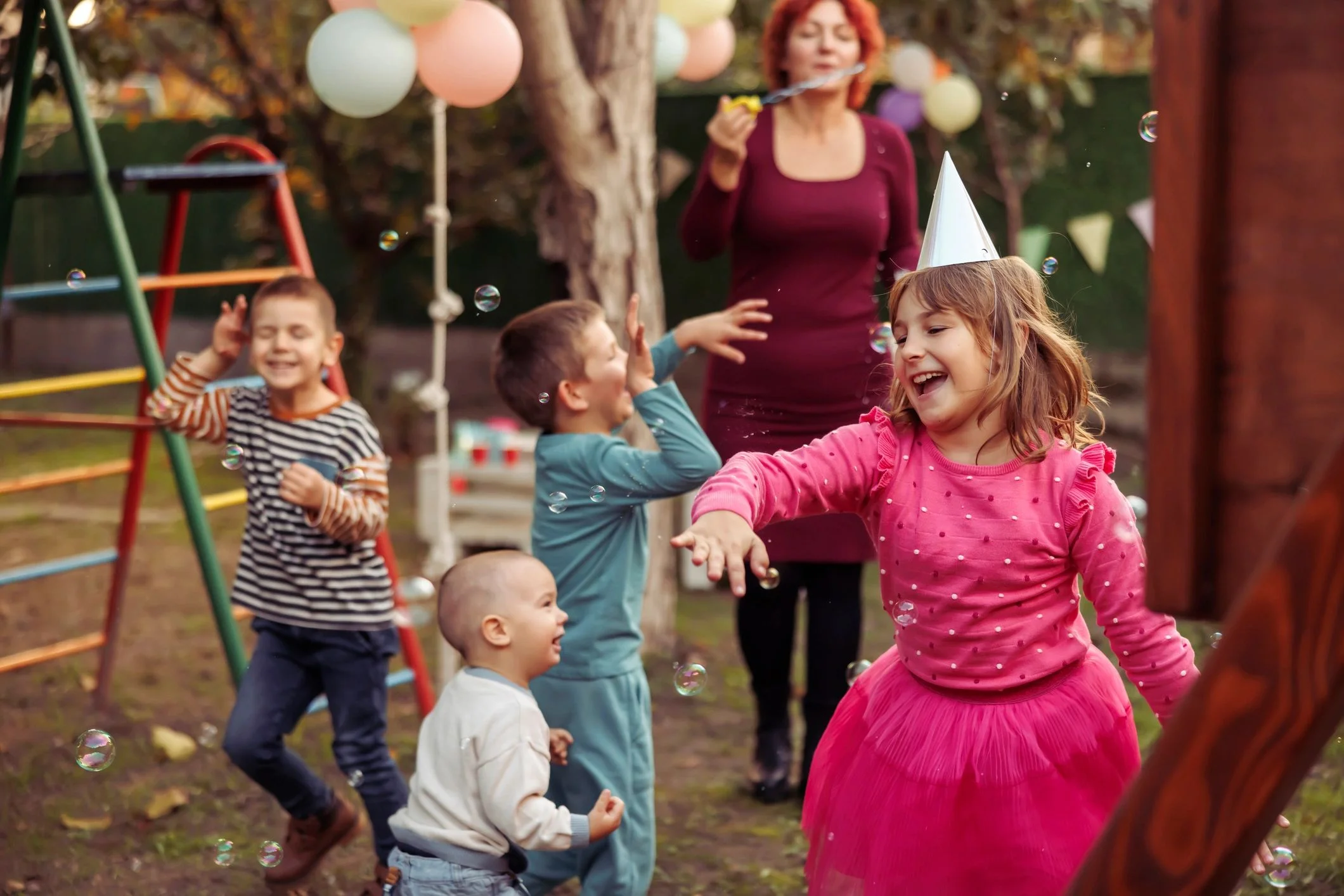 family enjoying bounce house rental at outdoor party